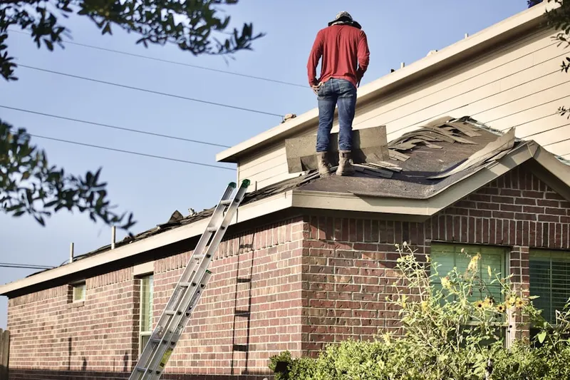 Professional roofer working on a residential roof in Hidden Lakes
